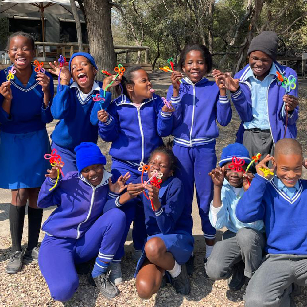 Photo of campers showing off their beautiful crafts. 